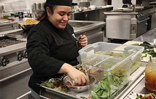 Culinary student preparing salad